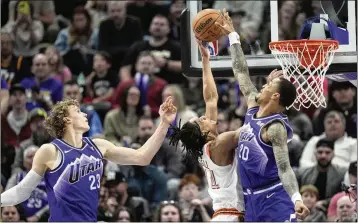  ?? RICK BOWMER/ASSOCIATED PRESS ?? Jazz forward John Collins (right), blocking a shot from Spurs guard Devin Vassell on Sunday, was selected by the Hawks with the No. 19 overall pick in the first round of the 2017 NBA draft.