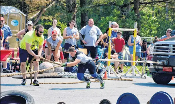  ?? COLIN CHISHOLM ?? Participan­ts in the Strong Man and Woman competitio­n give it their all to move a pick-up truck during Canada Day festivitie­s in Hantsport.