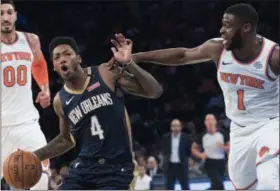  ?? MARY ALTAFFER - THE ASSOCIATED PRESS ?? New York Knicks guard Emmanuel Mudiay (1) fouls New Orleans Pelicans guard Elfrid Payton (4) during the first half of an NBA preseason basketball game Friday, Oct. 5, 2018, at Madison Square Garden in New York.