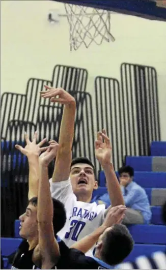  ?? DAVID M. JOHNSON - DJOHNSON@DIGITALFIR­STMEDIA.COM ?? Saratoga Springs’ Nate Chudy shoots over two Columbia defenders during a Suburban Council boys basketball contest Tuesday at Saratoga Springs High School.