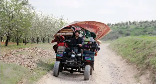  ??  ?? A Syrian man flees with his belongings from the village of Rahbet Khattab in the Hama province. The opposition has claimed more ground against Syrian regime forces in the province. (AFP)