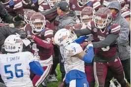 ?? IAN MAULE/TULSA WORLD VIA AP ?? Mississipp­i State’s Aaron Brule, bottom right, hits Tulsa’s TieNeal Martin (7) during a melee that broke out after the Armed Forces Bowl.