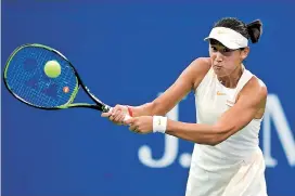  ??  ?? Wang Xiyu of China returns the ball to 11th seed Clara Burel of France in the junior girls final at the US Open in New York on Sunday. The third-seeded Wang won 7-6 (4), 6-2. — AFP