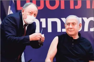  ?? Amir Cohen / Pool / AFP via Getty Images ?? Israeli Prime Minister Benjamin Netanyahu prepares to receive a coronaviru­s vaccine at the Sheba Medical Center in Ramat Gan near the coastal city of Tel Aviv, on Saturday.