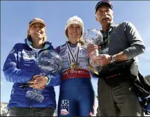  ?? Helen H. Richardson / The Denver Post ?? Mikaela Shiffrin stands with her parents Eileen, left, and Jeff Shiffrin, right, as they hold her overall World Cup Crystal Globe trophy, left, and her World Cup crystal globe for slalom, in her dad's hands at the base of Aspen Mountain after the 2017 Audi FIS Ski World Cup Finals on March 19, 2017 in Aspen.