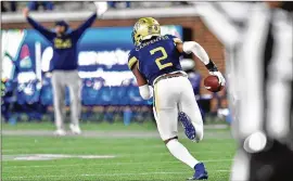  ?? HYOSUB SHIN / HYOSUB. SHIN@ AJC. COM ?? Defensive back Tariq Carpenter runs for a touchdown after he intercepte­d the ball in Tech’s 56- 33 win over Duke on Saturday.