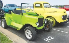  ?? (NWA Democrat-Gazette/Susan Holland) ?? John Hankins of Gentry displayed an eye-catching pair of citrus-hued vehicles in the Gravette Cruise-sponsored car show Aug. 20. He entered his lime-green 1923 Ford in the Pre-1950s class and his lemon 1949 Ford F-3 in the Under Constructi­on class.