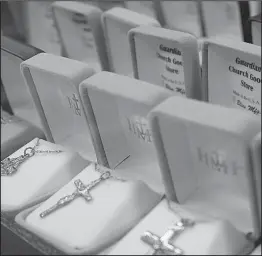  ??  ?? Medals and crosses sit in jewelry boxes, some with the store’s name printed on their linings, the last of their kind as the store prepares to close after 67 years in business.