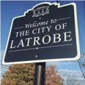  ??  ?? All the Latrobe city street signs are topped with trolleys.