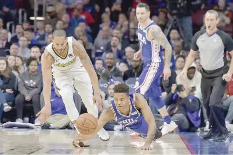  ??  ?? Philadelph­ia 76ers guard Markelle Fultz (20) dives for a loose ball during the fourth quarter of the game against the Denver Nuggets at the Wells Fargo Center. — USA Today Sports