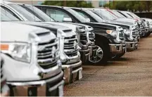  ?? Mark Mulligan / Houston Chronicle ?? Trucks are lined up at a Sterling McCall Toyota dealership.