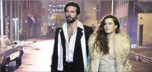  ?? COURTESY OF COLUMBIA PICTURES ?? Bradley Cooper (left), who stars in with Amy Adams, was shocked at what she was paid for the film.