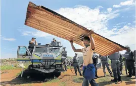  ?? Picture: Halden Krog ?? Scenes like this eviction at the Itireleng informal settlement, west of Pretoria, illustrate the urgency of resolving SA’s land-access issues.