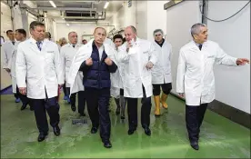  ?? ALEXEI DRUZHININ / THE NEW YORK TIMES ?? Russian President Vladimir Putin (center left) listens to Yevgeny Prigozhin (center right) during a tour of a school lunch factory outside St. Petersburg in 2010. Prigozhin was indicted by American prosecutor­s for his involvemen­t in interferin­g in the 2016 presidenti­al election.