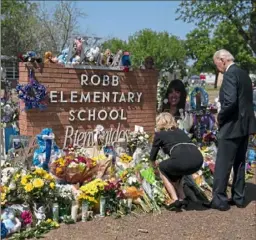  ?? Evan Vucci/Associated Press ?? President Joe Biden and first lady Jill Biden visit a memorial at Robb Elementary School to pay their respects to the victims of the mass shooting, May 29, in Uvalde, Texas.