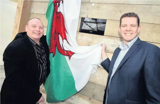  ??  ?? The plaque being unveiled by Neville Evans and Rhun ap Iorwerth AM at the opening