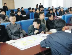  ?? IAN COLLINS / CHOSON EXCHANGE VIA BLOOMBERG ?? Participan­ts work on concept developmen­t during a startup boot camp workshop at the State Academy of Sciences in Pyongsong, North Korea.