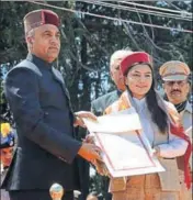  ?? DEEPAK SANSTA/HT ?? ■ CM Jai Ram Thakur felicitati­ng skier Aanchal Thakur during the 71st Himachal Day programme on The Ridge in Shimla on Sunday.