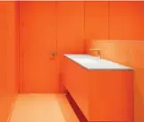  ??  ?? The family chose orange (shown here) and blue for bathrooms to work with matching ceramic tile.