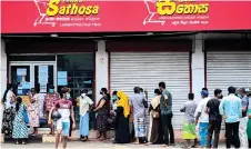  ?? ?? People queue outside a supermarke­t in Colombo following Sri Lanka’s declaratio­n of a state of emergency over food shortages as private banks ran out of foreign exchange to finance imports. The Sri Lankan government which defaulted on its US$46 billion external debt in April 2022 had hoped to finalise deals with foreign creditors by April but there have been no final agreements yet.