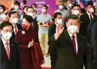  ?? COURTESY OF HKSAR GOVERNMENT ?? President Xi Jinping, along with his wife Peng Liyuan and accompanie­d by Chief Executive John Lee (left), waves goodbye to people seeing him off at the West Kowloon Station of the Guangzhou-Shenzhen-Hong Kong Express Rail Link on July 1.