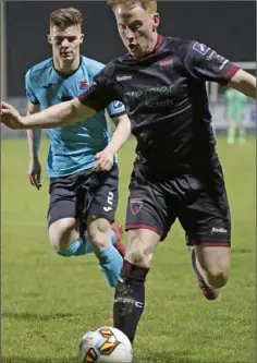  ??  ?? Chris Kenny of Wexford F.C. is watched by Cobh’s Charlie Fleming.