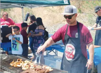  ?? Signal file photo ?? Ken Harris grills tri-tip and chicken at the 2018 Grill Master Challenge. This year’s challenge is scheduled for 11 a.m. to 3 p.m. April 13 at Wolf Creek Brewery, 27746 N. McBean Parkway in Valencia.