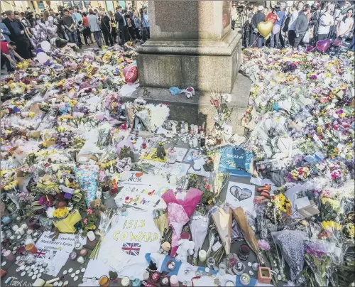  ?? PICTURE: DANNY LAWSON/PA ?? BROKEN HEART OF A CITY: The growing sea of floral tributes in St Ann’s Square, close to Manchester Arena, scene of the UK’s worst terror atrocity since 2005.