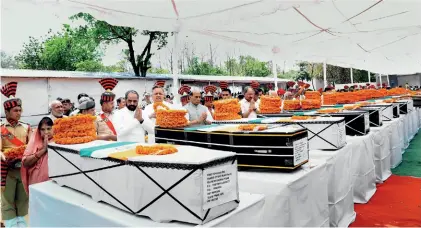  ??  ?? SAVAGE ATTACK Home minister Rajnath Singh and Chhattisga­rh CM Raman Singh pay tribute to the CRPF troopers killed by Maoists in Chhattisga­rh on April 24