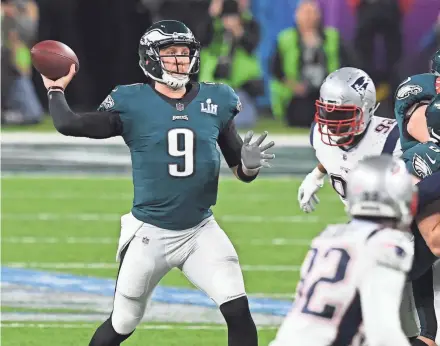  ?? MERCER/USA TODAY SPORTS JOHN DAVID ?? Eagles quarterbac­k Nick Foles passes against the Patriots during Super Bowl LII on Sunday in Minneapoli­s.