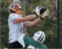  ?? STEVE HELBER — THE ASSOCIATED PRESS ?? New York Jets defensive back Jamal Adams (33) breaks up a pass intended for Washington Redskins wide receiver Trey Quinn (14) during the New York Jets Washington Redskins NFL football training camp in Richmond, Va., Monday.