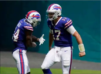  ?? AP PHOTO/WILFREDO LEE ?? Buffalo Bills quarterbac­k Josh Allen (17) celebrates with wide receiver Stefon Diggs (14) after Diggs scored a touchdown during the first half of an NFL football game against the Miami Dolphins, Sunday, in Miami Gardens, Fla.