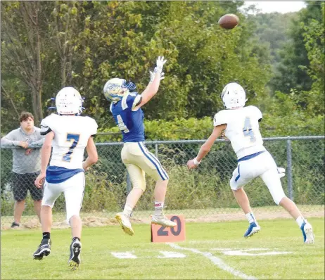  ?? Westside Eagle Observer/MIKE ECKELS ?? Bulldog Landon Watson (center) leaps up to catch a Bryson Funk pass from deep inside Bulldog territory Friday during the first quarter of the Decatur-Spring Hill game in Decatur. The ball hit its target, and Watson managed another five yards before being tackled near the 15-yard line.