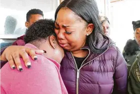  ?? Mike De Sisti / Associated Press ?? Bernice Parks, left, is consoled after the death of her “angel” Sandra, 13, who recently was killed when a stray bullet went into her home in Milwaukee.