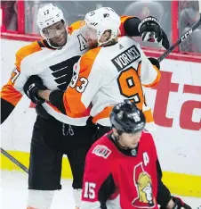  ?? ADRIAN WYLD/CP ?? Ottawa forward Zack Smith skates away as Philadelph­ia’s Jakub Voracek celebrates a goal with teammate Wayne Simmonds.