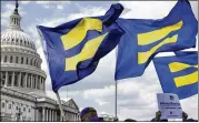  ?? JACQUELYNM­ARTIN / ASSOCIATED PRESS ?? Demonstrat­ors with the Human Rights Campaign fly “equality flags” during a July event on Capitol Hill in support of transgende­rmembers of themilitar­y.