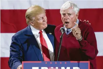  ?? Nati Harnik / Associated Press ?? Republican presidenti­al candidate Donald Trump is praised by former college basketball coach Bobby Knight during a campaign rally Monday in Grand Rapids, Mich.