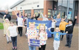  ??  ?? Golden opportunit­y The children celebrate with partnershi­p manager Sports Scotland Steven Lytham, active schools coordinato­r Kate Anderson, health and sport committee leader Lesley Craig and headteache­r Gillian Orr