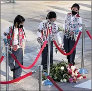  ?? ?? Members of the Chief Plenty Coups Honor Guard lay flowers and salute Tuesday at the front of the Tomb of the Unknown Soldier Plaza for the centennial commemorat­ion in Arlington, Va.
Crow Nation citizens and representa­tives, including students from Plenty Coups High School, lay flowers Tuesday at the front of the Tomb of the Unknown Soldier Plaza.