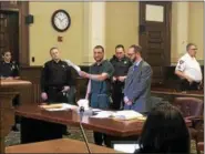  ?? NICHOLAS BUONANNO — NBUONANNO@TROYRECORD.COM ?? Defendant Johnny Oquendo holds up pre-sentencing papers as he explains to Rensselaer County Supreme Court Judge Andrew Ceresia why he needs more time to review the documents before being sentenced. Standing next to Oquendo is conflict defender Trevor...