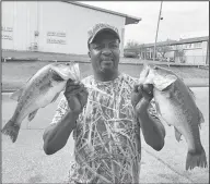  ?? Janice McIntyre/News-Times ?? Big catches: Ricky Johnson of Calion caught these two big bass – weighing in at four and five pounds – on Calion Lake. Johnson said he caught the fish on a ‘blue deep diver’ bait.