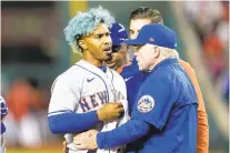  ?? ALEX BRANDON/AP ?? New York Mets shortstop Francisco Lindor, left, is pulled from the game by manager Buck Showalter, right, after he was hit by a pitch from Washington reliever Steve Cishek on Friday night.