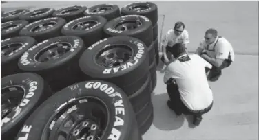  ??  ?? In this April 3, 2014, file photo, Goodyear tire technical officials, whom did not wish to be identified, discuss tires at the Texas Motor Speedway in Fort Worth, Texas. Three NASCAR championsh­ip contenders had tire problems in the Oct. 5 Sprint Cup...