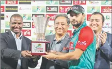  ??  ?? Bangladesh’s captain Mashrafe Mortaza (second right), receives the winner’s trophy for their series against Zimbabwe in Dhaka, Bangladesh, on Nov 11. (AP)