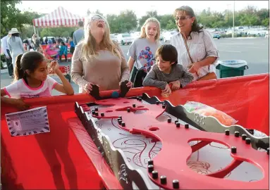  ?? RECORDER PHOTOS BY CHIEKO HARA ?? Lisa Lebrun, second from left, reacts while playing Snake Run with family and friends Friday, Nov. 2, 2018 at Sierra View Medical Center’s employee appreciati­on carnival.
