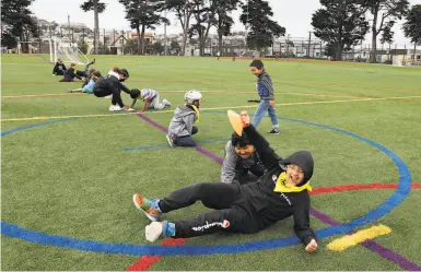  ?? Photos by Liz Hafalia / The Chronicle ?? Top: Ricky Moran, 9, plays with his brother at the center in San Francisco’s OceanviewM­ercedIngle­side neighborho­od.