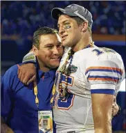  ?? MARK HUMPHREY / ASSOCIATED PRESS ?? Then-offensive coordinato­r Dan Mullen hugs Tim Tebow after the Gators beat Oklahoma in the national title game on Jan. 8, 2009.