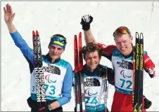  ?? AP PHOTO ?? Winners of the men’s 12.5-kilometre biathlon event, from left, silver medallist Ihor Reptyukh of Ukraine, gold medallist Benjamin Daviet of France and bronze medallist Mark Arendz of Canada pose for photos during a ceremony at the Winter Paralympic­s in...