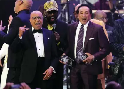  ?? AP PHOTO/CHRIS PIZZELLO ?? Berry Gordy, left, and Smokey Robinson, right, accept their MusiCares Person of the Year awards Friday at a celebratio­n in their honor at the Los Angeles Convention Center.