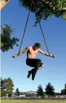  ?? — AFP ?? An aerial straps artiste trains for his act using a tree at Sunset Park in Las Vegas on Monday.